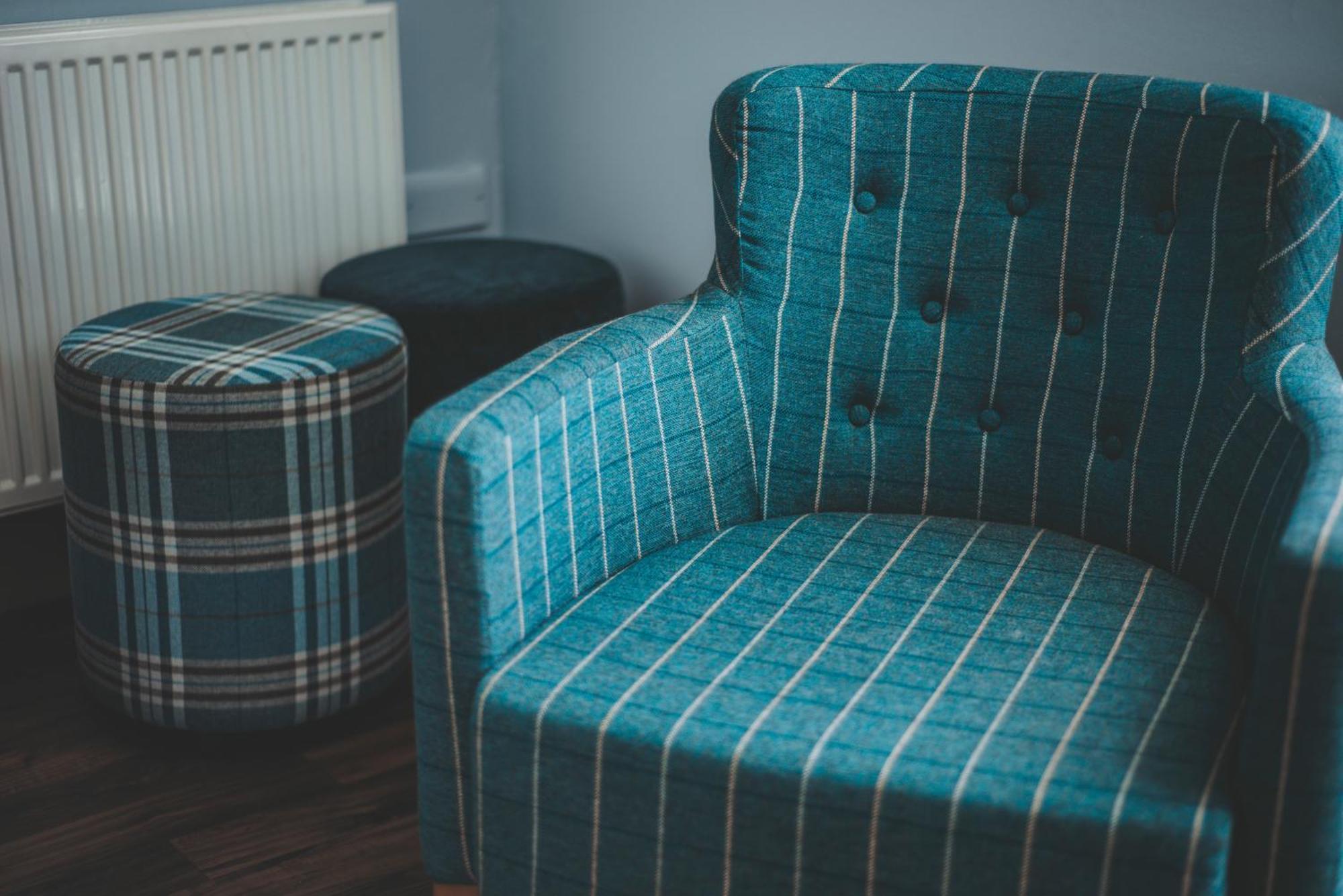 Oban Youth Hostel Kültér fotó A chair and stool upholstered in tartan